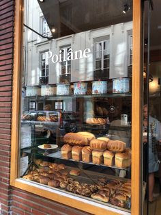 a bakery window filled with lots of baked goods