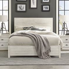 a bedroom with gray walls and white furniture