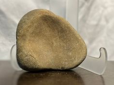 a rock sitting on top of a table next to a knife