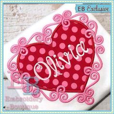 a red heart with the word love on it in white and pink polka dot fabric