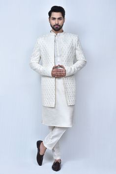 Cream sherwani with thread, sequin embroidery in mughal pattern. Paired with kurta and straight pant.
Components: 3
Pattern: Embroidery
Type Of Work: Thread, sequin, mughal
Neckline: Mandarin collar
Sleeve Type: Full sleeves
Fabric: Art Silk
Color: Cream
Other Details: 
Front concealed button placket
Side pockets
Elasticated waistband
Occasion: Destination Wedding - Aza Fashions Cream Sherwani, Mughal Pattern, Wedding Kurta For Men, Embroidered Sherwani, Cream Art, Rohit Bal, Tarun Tahiliani, Sequin Embroidery, Thread Art