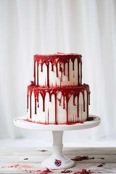 a red and white cake with dripping icing