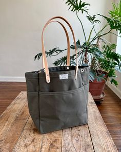 This versatile, fun tote is our best selling go-to for daily carry. Small batch handmade in our Omaha, NE studio using sturdy water repellent duck canvas and American full grain leather. Large Capacity Duck Canvas Bag For On-the-go, Waxed Canvas Bag With Leather Handles For On-the-go, Double Handle Canvas Bag For On-the-go, Practical Duck Canvas Bags For Everyday Use, Green Canvas Bag With Leather Handles For On-the-go, Casual Double Handle Waxed Canvas Bag, Everyday Canvas Bag With Duck Canvas Lining, Duck Canvas Bag With Leather Handles For Everyday Use, On-the-go Canvas Bag With Reinforced Handles