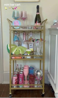 a bar cart filled with lots of bottles and glasses