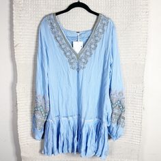 Free People Wild One Dress In Blue Skies. Light Blue With Orange And Green Embroidery. V-Neck. Long Billowy Sleeves. Ruffled Hem. Tunic Silhouette. Mini Length. Measurements: 19.5” Bust, 20” Waist, 32.5” Length Material: No Tag Condition: Brand New With Tags. No Flaws. Spring, Summer, Vacation, Beach, Cruise, Casual, Fall, Winter, Formal, Wedding Guest, Cocktails, Gala, Thanksgiving, Christmas, Holidays, Party, Birthday, Bachelorette, Going Out, Date Night, Valentine's Day, Bridal Shower, Bachel Light Blue Embroidered Beach Dress, Blue V-neck Boho Dress For Spring, Summer Mini Dress With Embroidered Hem And Long Sleeves, Long Sleeve Mini Dress With Embroidered Hem For Summer, Blue Floral Embroidered Mini Dress For Vacation, Spring Long Sleeve Mini Dress With Embroidered Hem, Blue Floral Embroidery Mini Dress For Vacation, Light Blue Long Sleeve Dress With Floral Embroidery, Blue V-neck Dress With Embroidered Hem