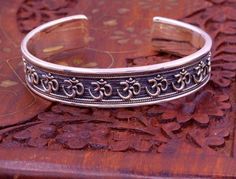 Excellent handmade 925 sterling silver Hindu mantra Aum bracelet, vintage antique stylish unisex gifting oxidized jewelry from Rajasthan india.Metal-925 sterling silver.Type-Bracelet/ kada.Size-Adjustable.Width-1.4 centimeters.Weight-42.470 grams approx.Finish-Oxidized.Stamped-925.Makes excellent gifting for birthday, wedding anniversary, mother's day, father's day Ganesha Pendant, Handmade Hoop Earrings, Adjustable Bangle Bracelet, Adjustable Bangle, Oxidised Jewellery, Rajasthan India, Bracelet Vintage, Sterling Silver Hoop Earrings, Temple Jewellery