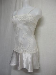 "Short White Lace and Satin Nightgown Unbelievably adorable! Sheer Baby doll /white nightie! Tons of lace with a satin flouncy skirt This is sassy! (Like You!) Small 36\" bodice 40\" Hip 32\" length Easy care poly GREAT for brides! https://www.etsy.com/shop/BelindasStyleShop" Lace Nightgown Camisole For Night, Lace Camisole Nightgown, Sheer Lace Slip Dress For Sleep, Lace Chemise With Delicate Lace For Night, Feminine Lace Chemise For Sleep, Coquette Slip Dress With Lace Trim For Sleep, White Sheer Satin Dresses, Lace Sleepwear With Delicate Lace For Night, Delicate Lace Sleepwear For Night