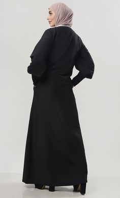 A perfect wardrobe piece for everyday Round neck with contrast piping Button down (4 buttons) Upper flared shrug with button Both side pockets Full Sleeves with ruched cuffs FABRIC:Kashibo CARE: Very Light Machine wash cold NOTE:-Recommended to be worn over warm lining in winters Oversized Black Abaya, Oversized Black Long Sleeve Abaya, Oversized Long Sleeve Black Abaya, Long Sleeve Abaya For Work, Solid Color Long Sleeve Abaya For Work, Solid Long Sleeve Abaya For Work, Long Sleeve Abaya For Formal Fall Occasions, Long Sleeve Abaya For Formal Fall Events, Modest Solid Color Workwear Abaya