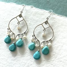 Fun Chinese turquoise is combined with freshwater pearls on sterling silver balinese chandeliers. The approximate length is 2". Please choose your earwire preference. Your earrings will arrive beautifully giftboxed. Handmade Turquoise Chandelier Earrings In Sterling Silver, Nickel-free Sterling Silver Turquoise Chandelier Earrings, Turquoise Sterling Silver Chandelier Earrings, Turquoise Teardrop Chandelier Earrings In Sterling Silver, Turquoise Sterling Silver Dangle Chandelier Earrings, Handmade Turquoise Dangle Pearl Earrings, Pearl Chandelier Earrings, Framed Jewelry, Pearl Chandelier