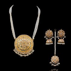 Explore the timelessness of magnificent ornaments rooted in tradition! Experience a contemporary nod on classic thappa kundan set crafted with pearl moti to attain a resplendent look. The set includes a mala, a maang teekah and a pair of beautiful earrings. Gold-plated on high-quality brass as base metal. In-stock & ready-to-ship. *Please Note: We use faux stones and beads in all of our jewelry. White Kundan Necklace For Puja And Eid, Traditional Jewelry For Puja With Mirror Work, Traditional Jewelry With Mirror Work For Puja, Kundan Chandbali Necklace For Eid Puja, Chandbali Kundan Necklace For Eid Puja, Kundan Temple Necklace For Eid, White Kundan Jewelry Sets For Puja, White Jewelry For Puja And Eid, Elegant Kundan Jewelry Sets For Puja