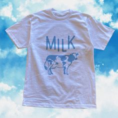 This retro kawaii clothing was inspired by japanese kawaii aesthetic and kawaii fashion. This kawaii t shirt features a retro - grunge textured vintage inspired Milk Print with originally designed cow on it. It's perfect for any pastel clothing lovers who just want to keep it minimal for their every day. It's a perfect gift for her, gift for him or anyone in between as these shirts are unisex. Available in Sizes XS, S, M, L, XL, 2XL and 3XL. ✨ 100% ⭐️ PREMIUM ⭐️ Airlume combed and ringspun cotto Kawaii Cotton T-shirt With Letter Print, White Kawaii Tops With Graphic Print, White Kawaii Top With Graphic Print, Cute White Cotton T-shirt, Kawaii Cotton Shirt With Cartoon Print, Kawaii White Top With Funny Print, Kawaii Crew Neck Shirt With Letter Print, Cotton Kawaii Shirt With Cartoon Print, Cute White T-shirt For Streetwear