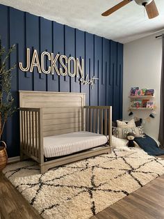 a baby's room with blue walls and wooden furniture