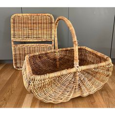 two wicker baskets sitting on top of a wooden floor