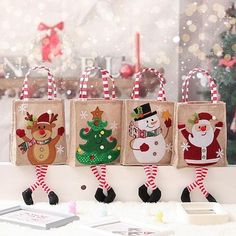 four christmas bags with santa and snowmen on them