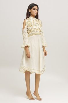 Cream dress with floral embroidered yoke, stripe embroidery on the sleeves and hemline. - Aza Fashions Festive Off-white Dress With Floral Embroidery, Festive Off-white Floral Embroidered Dress, Festive Off White Floral Embroidery Dress, Elegant Festive Dresses With Embroidered Hem, Elegant Cotton Dresses With Yoke, Spring Festive Dress With Embroidered Hem, Festive Embroidered Hem Dress, Traditional Midi Dress For Spring Festivals, White Embroidered Neckline Kurta For Spring