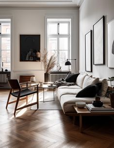 a living room filled with furniture and lots of windows