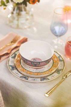 a white table topped with plates and cups