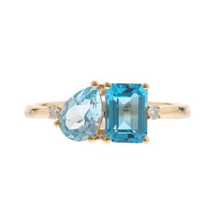 This blue topaz and diamond accent ring makes a stylish statement with luminous gemstones in an alluring modern design. Crafted in glistening 10K yellow gold, this ring features one emerald cut blue topaz artistically set alongside one pear-shaped blue topaz in eye-catching shades of blue, complemented by two round full cut diamond accents. | Blue Topaz and Diamond Accent Ring | 10K Yellow Gold | Size 6.5 | 2mm | Helzberg Diamonds Modern Topaz Ring With Gemstone Accents For Anniversary, Modern Blue Topaz Ring With Diamond Accents, Measure Ring Size, Country Rings, Helzberg Diamonds, Topaz Stone, Anniversary Bands, Fine Jewelry Gift, Ring Size Guide