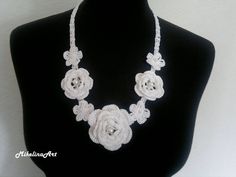 Ready to ship worldwide! Crochet necklace. Length: 53 cm (21.2 inches) + ties 34 cm (13.6 inches) on each side. Flower size: 4 small flowers: 3 cm (1.2 inches). 2 medium sized roses: 4.5 cm (1.8 inches). 1 large rose: 6 cm (2.4 inches). 100% cotton. Feel free to ask me any questions. Ready to ship in 2-3 business days. The list of items will be growing so stay tuned. Thank You. Elegant Adjustable Crochet Jewelry, Elegant Necklace With Handmade Flowers For Gifts, Elegant Handmade Flower Necklaces, Adjustable, Elegant Adjustable Necklace With Handmade Flowers, Elegant Crochet Jewelry With Flower Shape, Elegant White Crochet Necklace, White Flower Bridal Necklace As Gift, Adjustable Crochet Flower Necklace, White Crochet Jewelry As Gift