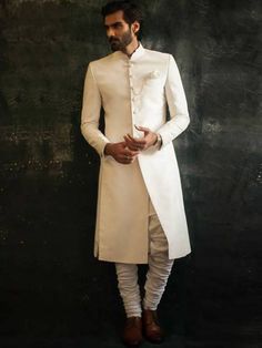 White Long Bandhgala For Eid, White Long Nehru Jacket With Dabka, Unstitched White Long Sherwani, Long White Nehru Jacket With Dabka, Fitted White Long Churidar, White Long Sherwani For Eid, White Long Bandhgala With Dabka, Formal White Churidar With Dabka Detailing, White Fitted Churidar For Ceremonial Occasions