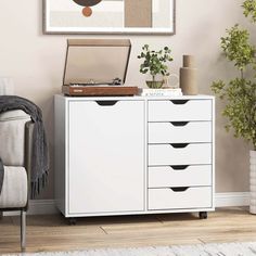 a white cabinet with drawers in a living room