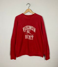 "*ITEM: Vintage 90s Wisconsin Hockey Wisconsin Badgers Sweatshirt Large Vintage 1990 Wisconsin Hockey Sportwear Pull Over Crewneck Sweatshirt Size L *ITEM DETAILS: 👇🏻 Please be aware that all vintage items will usually show a few signs of wear or fading due to age, but anything visible such as stains or holes, and serious flaws have been photographed.For any further information on this item please contact us and we will be happy to help. *SIZE: *ACTUAL SIZE MEASUREMENT: 👇🏻 *PIT TO PIT(WIDTH) Vintage Red Crew Neck Tops, Throwback Long Sleeve Top With Screen Print, Vintage Screen Print Tops For Winter, Winter Vintage College T-shirt, Banff Canada, Wisconsin Badgers, Sweatshirt Vintage, 로고 디자인, Vintage Sweatshirt