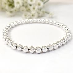 ✦Material: Sterling Silver ✦Shape: Round  ✦Bead Size: 5mm ✦Length: 5''- 9'' ✦QTY: 1 pc / package ✦✦Please measure your wrist size, then order the bracelet. Enhance your jewelry collection with our 925 Sterling Silver Beaded Bracelet from Ny6design. This premium custom jewelry piece features 5mm round beads in a minimalist stretch design, offering both elegance and versatility. Handmade in the USA, this bracelet is perfect for stacking and makes a thoughtful gift for any occasion. ◾High Quality: Made with 925 sterling silver, ensuring durability and a beautiful, long-lasting shine. ◾Handcrafted Excellence: Each bead is carefully selected and hand-strung, reflecting the artisan's attention to detail in USA. ◾Thoughtful Gift: Ideal for anyone who appreciates premium quality jewelry and tradit Minimalist Sterling Silver Bracelet With Spacer Beads, Elegant Sterling Silver Stretch Bracelet With Silver Beads, Minimalist Sterling Silver Bracelet With Round Beads, Elegant Silver Stretch Bracelet With Polished Beads, Elegant Sterling Silver Stretch Bracelet With Round Beads, Elegant Sterling Silver Stretch Bracelet, Minimalist Sterling Silver Bracelet With Hypoallergenic Round Beads, Minimalist Silver Beaded Bracelets With Polished Beads, Elegant Silver Stretch Bracelet With 8mm Beads