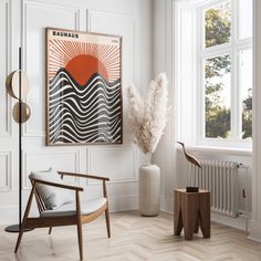 a living room with white walls and wood flooring, an art work on the wall