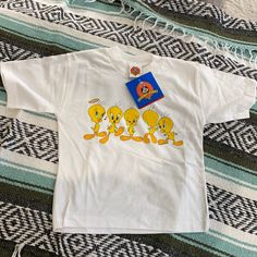 New Vintage 1998 Looney Tunes Tweety Bird Single Stitch T Shirt Size White Small Please See Measurements Casual Yellow Shirt With Cartoon Print, Retro Yellow T-shirt For Fan Merchandise, White Y2k T-shirt With Character Print, White 90s Cartoon Print Top, Y2k White T-shirt With Character Print, Yellow Crew Neck T-shirt In Y2k Style, Yellow Cotton Tops With Cartoon Print, White 90s T-shirt With Character Print, Cute Yellow Pre-shrunk Tops