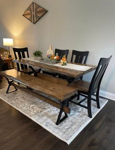 a dining room table with benches and chairs