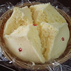 a basket filled with white cake sitting on top of a table