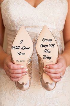 a bride holding her wedding shoes with the words i every step off the way on them