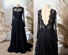 a black lace dress with long sleeves and open back, on a mannequin