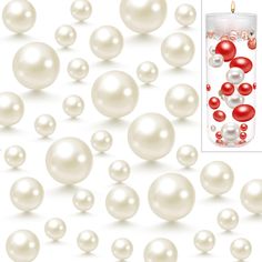 a candle surrounded by white pearls and red balls on a white background with an advertise