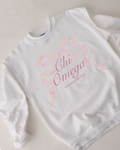 tied together with a bow <3 ♡ Super soft sweatshirt comes in unisex sizing! Reference the size chart for additional details. It is recommended to SIZE UP for an oversized fit   ♡ Sweatshirt comes in white with a light pink print. Please check listing photos for color reference! ♡ Please make sure you are ordering for the correct sorority before placing an order! This listing is for CHI OMEGA. We are unable to accept returns or exchanges for this since all items are made to order.   ♡ INSTRUCTIONS FOR CARE:  1. Turn inside out before washing  2. Wash on a gentle cycle  3. Recommended not heat dry to prevent any minimal shrinking, hang to dry instead ♡ It is important that you LOVE your product! If you have any questions or concerns upon receiving your product, please contact me immediately Bow Sorority Merch, Sorority Moms Day Shirts, Cotton Sorority Sweatshirt With Graphic Print, Cotton Sweatshirt With Graphic Print For Sorority, Sorority Long Sleeve Graphic Sweatshirt, Sorority Graphic Print Long Sleeve Sweatshirt, Sorority Long-sleeve Cotton Sweatshirt, Cotton Sorority Sweatshirt With Long Sleeves, Cotton Long Sleeve Sorority Sweatshirt