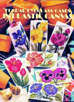 cross stitch pattern book with flowers and potted plants on the cover, all in different colors