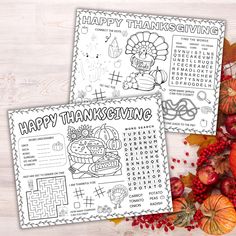 two thanksgiving worksheets with pumpkins, apples and other autumn items on a table