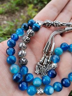 ✔️ This personalized rosary made by using 8 mm high grade Madagascar Blue Agate stone beads. ✔️ Natural Stone ✔️ Natural Color ✔️ This customized tasbih is a very special gift for your loved ones. ✔️ Each order comes in a special box. ✔️ PLEASE CLICK THE LINK FOR ALL PRAYER BEADS MODELS https://www.etsy.com/shop/GoodJewelsofYazmasal Note: As a natural feature the stones beads may have some variations. SHIPPING: United States (Standart/DHL eCommerce/usps): 7-10 business days United States (Expres Traditional Rosary Bracelet With 8mm Beads As Gift, Round Beads Rosary With Natural Stones For Gift, Adjustable Rosary With 108 Beads As Gift, Rosary With 8mm Round Beads As Gift, Gift Rosary With 8mm Round Beads, 8mm Round Bead Rosary As Gift, Turquoise Rosary Bracelet With Round Beads As Gift, Blue Rosary With Round Beads For Gift, Blue 108 Beads Spiritual Rosary