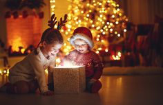 two children are playing with a lit box