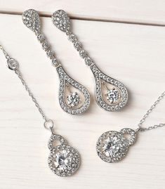 Bridal Accessories, Silver Jewelry, Teardrop Earrings, Jewelry Earrings, Dainty Earrings, Cubic Zirconia Earrings ► Spend $200 | Receive 10% OFF Your Order with Code: 10OFF200 ► Please note in your order when your wedding date is Classic linear 18K white gold earrings decorated in cubic zirconia pave crystals. Complete the look with a side-swept bun for an angelic yet sultry look. MATERIALS & MEASUREMENTS - 18K White Gold or Gold over Brass - Cubic Zirconia Pave Crystals - Hypoallergenic, le Anniversary Jewelry Sets With Drop Earrings, Elegant Jewelry Sets With Matching Dangle Earrings, Teardrop Jewelry Sets With Matching Earrings For Anniversary, Anniversary Teardrop Jewelry Set With Matching Earrings, Cubic Zirconia Jewelry Sets With Dangle Earrings, Unique Wedding Earrings, Silver Bridal Earrings, Side Swept, Back Necklace