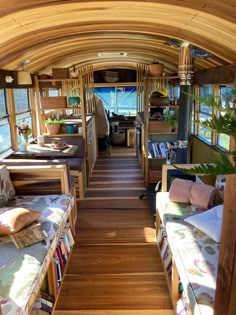 the inside of a bus with lots of windows and couches on each side of it