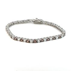 Introducing our stunning Rhodium-Plated Italian-Made Tennis Bracelet, a harmonious fusion of Italian craftsmanship and timeless elegance. Crafted with meticulous attention to detail in Italy, this bracelet is adorned with exquisite white and cognac-coloured stones set in .925 Italian Silver, creating a mesmerizing symphony of colour and brilliance. Each stone is carefully selected for its impeccable clarity and captivating hue, expertly set within the shimmering links of the bracelet. The altern Timeless White Sterling Silver Bracelet With Diamond Accents, Classic White Sterling Silver Bracelet With Diamond Accents, Formal White Tennis Bracelet With Diamond Accents, Elegant White Tennis Bracelet With Diamond Accents, Elegant White Bracelets With Diamond Accents, White Bracelet With Diamond Accents For Anniversary, White Gold Bracelets With Elegant Design For Formal Events, White Diamond Accent Bracelet For Anniversary, White Bracelets With Diamond Accents For Anniversary