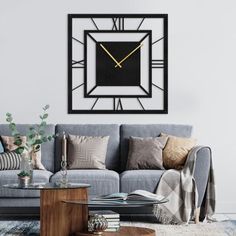 a living room with a couch, coffee table and large clock mounted on the wall