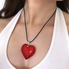 This Coquette Jewelry gift for her features a big red heart necklace with a chunky, large heart pendant, perfect for women who adore grunge chunky charm. Complete with a leather cord necklace, it's an ideal statement piece. 𝐃𝐄𝐓𝐀𝐈𝐋𝐒:  ⭐️ Black cord necklace lengths available: 50cm ⭐️ Red Glass Heart Pendant size is 43mm ⭐️ Red heart pendant is made out of glass & includes a black cord necklace ⭐️ The perfect statement piece, The Lover Girl Heart Necklace   ⭐️ ALL jewelry include 1 year war Trendy Red Heart Pendant Necklace, Trendy Red Heart Necklace For Valentine's Day, Big Heart Necklace, Coquette Jewelry, Red Heart Necklace, Lover Girl, Leather Cord Necklace, The Lover, Leather Corded Necklace