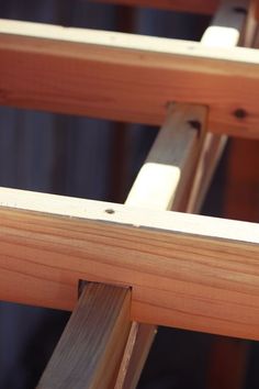 a close up of some wooden chairs with wood slats