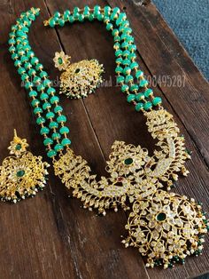 Most beautiful gold replica  pendent set with emrald beads  look.very grand and real one perfect for a Indian bridsl Traditional Kundan Necklace With Meenakari And Emerald, Green Intricate Design Jewelry For Puja, Traditional Kundan Emerald Necklace For Festivals, Green Intricate Jewelry For Puja, Traditional Emerald Kundan Necklace For Festivals, Green Jewelry With Intricate Design For Puja, Festive Green Temple Necklace With Stone Work, Festive Meenakari Emerald Chandbali Necklace, Traditional Meenakari Emerald Necklace