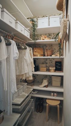 an organized closet with white shelves and drawers