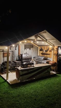 a mobile home with an outdoor kitchen and grill area in the back yard at night