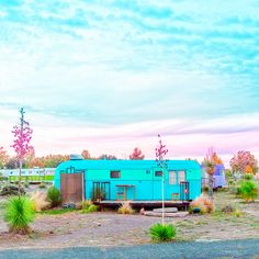 a blue trailer sitting in the middle of a field