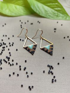 Embrace the allure of tribal artistry with our 'Spirit Triangle Earrings.' Each earring weaves a captivating Native American-inspired pattern in hues of black, bronze, blue and white. The subdued elegance meets vibrant energy, creating a harmonious balance.  Adorn yourself with these geometric treasures, where the Spirit Triangle Earrings embody the essence of tribal chic, adding a touch of bold style to your look. Handcrafted with love & precision, utilizing the ancient technique of bead weavin Adjustable Geometric Beaded Jewelry, Handmade Minimalist Hoop Earrings For Party, Minimalist Handmade Hoop Earrings For Party, Minimalist Earrings With Dangling Beads As Gift, Minimalist Adjustable Beaded Earrings For Gift, Handmade Geometric Jewelry For Party, Handmade Minimalist Beaded Dangle Earrings, Minimalist Handmade Beaded Dangle Earrings, Handmade Beaded Drop Earrings For Celebration